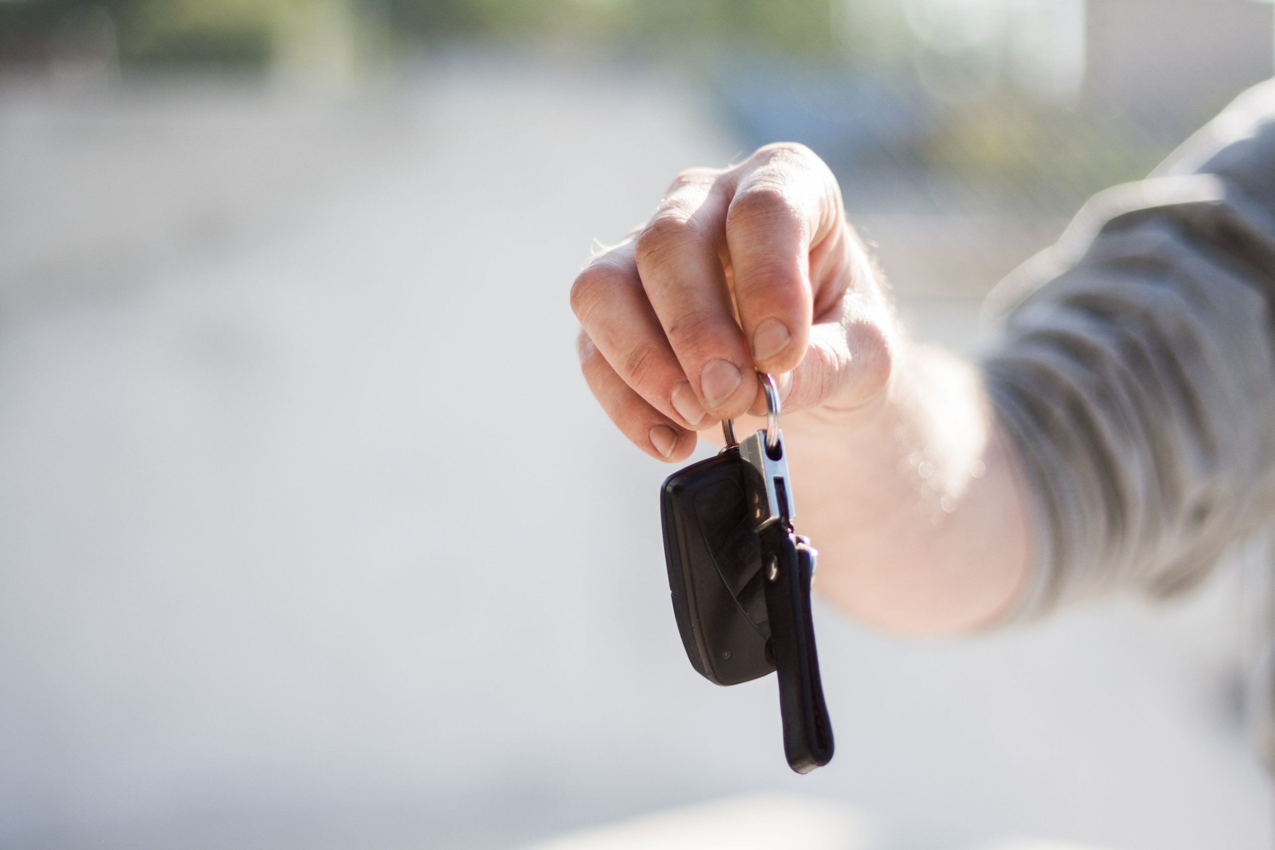 young driver holding new car keys
